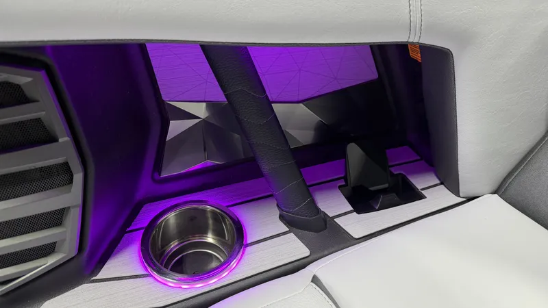 Slide: The Image of Close-up of a boat interior with purple lighting and a cup holder. - 50