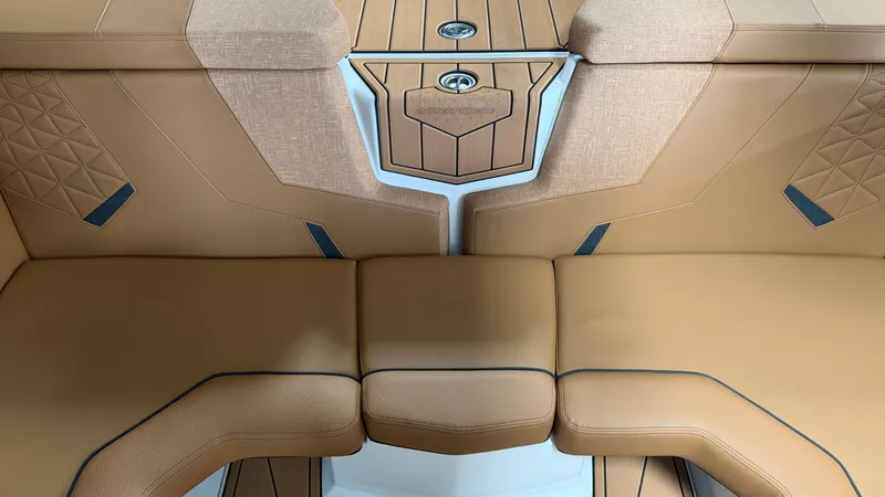 Slide: The Image of The image shows the interior of a 2026 Nautique Super Air Nautique GS20 with beige upholstery. - 34