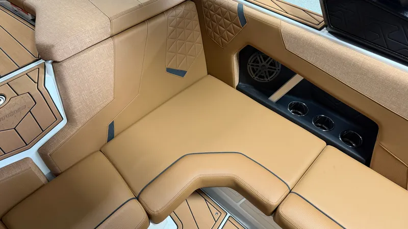 Slide: The Image of The image shows a luxurious beige upholstered seat with diamond stitching and cup holders. - 36