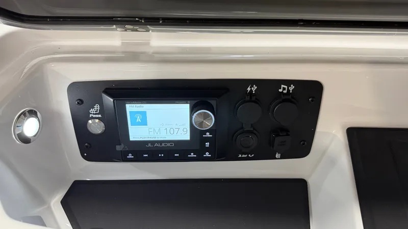 Slide: The Image of The image shows a JL Audio control panel with a display showing FM 107.9. - 49
