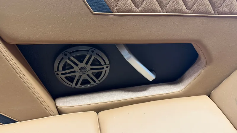 Slide: The Image of Close-up of a speaker and armrest in a 2026 Nautique Super Air Nautique GS20. - 43