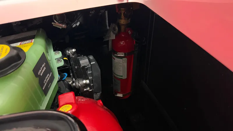 Slide: The Image of Close-up of the engine compartment of a Nautique Super Air Nautique GS20 with a fire extinguisher. - 27