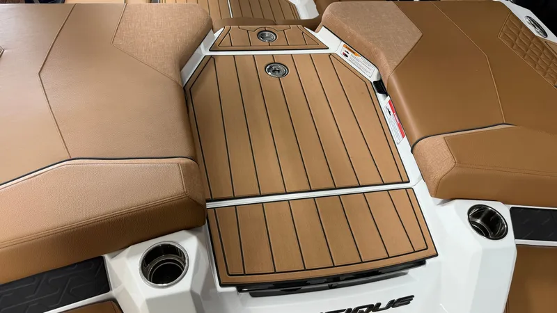 Slide: The Image of The image shows the deck of a 2026 Nautique Super Air Nautique GS20 with brown upholstery. - 17