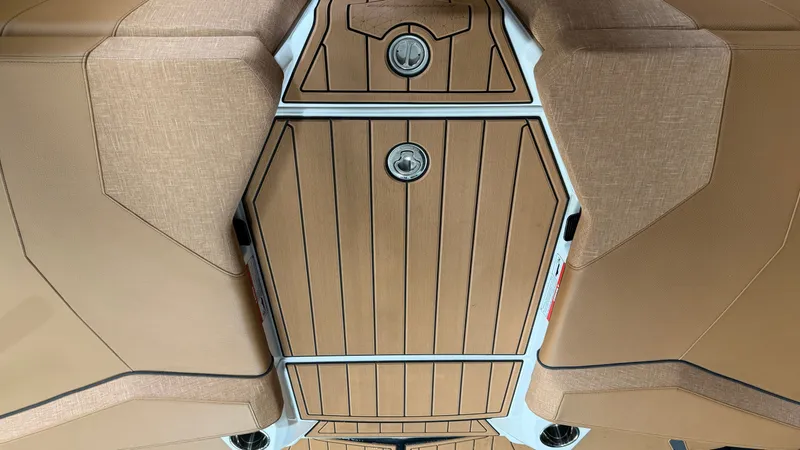 Slide: The Image of The image shows the deck of a 2026 Nautique Super Air Nautique GS20 with sleek wood elements. - 24