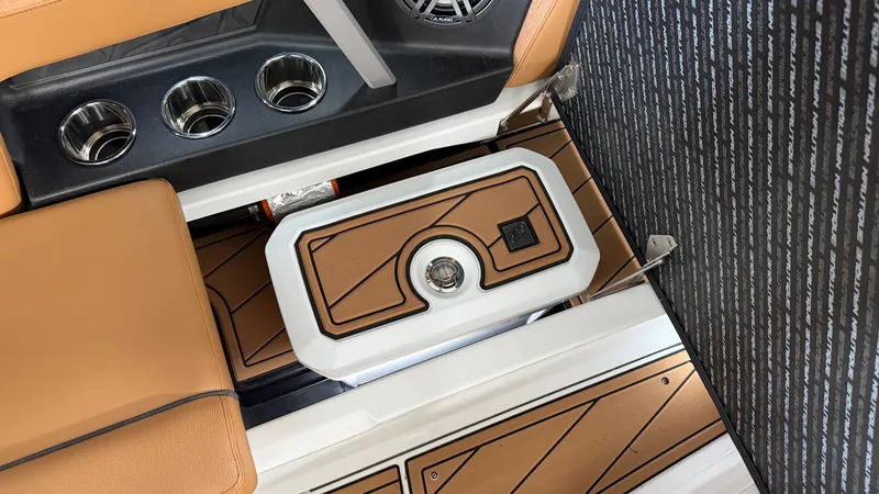 Slide: The Image of Interior of the Nautique Super Air Nautique GS20 with brown upholstery and cup holders. - 32