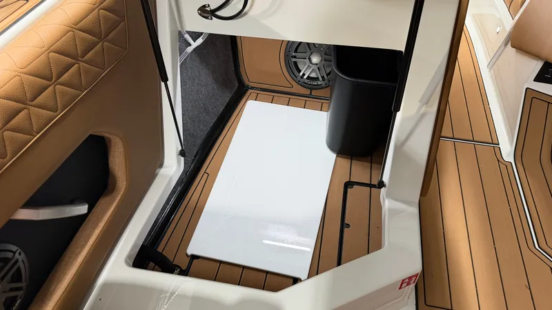 Slide: The Image of Interior of a 2026 Nautique Super Air Nautique GS20 with brown upholstery and speakers. - 44