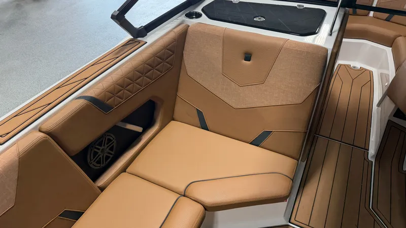 Slide: The Image of Interior of a 2026 Nautique Super Air Nautique GS20 with brown upholstery and modern detailing. - 42