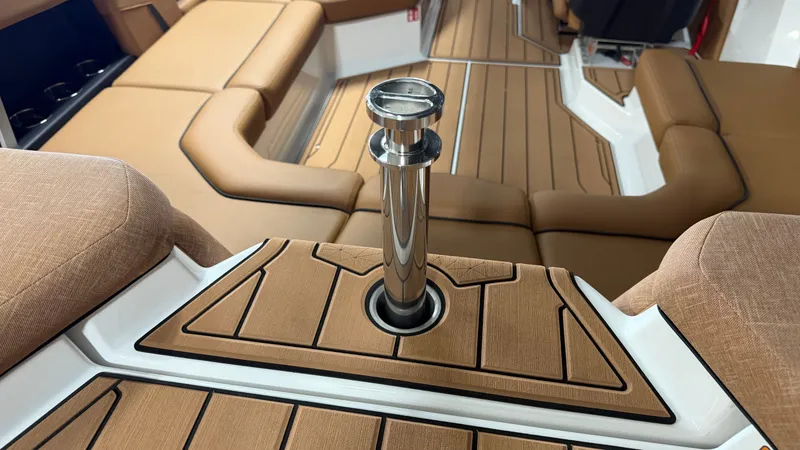 Slide: The Image of The image shows the interior of a 2026 Nautique Super Air Nautique GS20 with brown upholstery and a stainless steel feature. - 18
