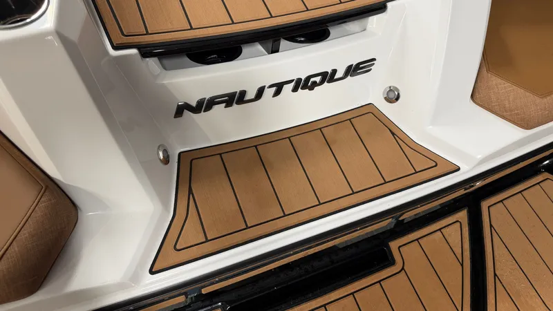 Slide: The Image of The image shows the deck of a 2026 Nautique Super Air Nautique GS20 with a wood-like finish. - 16