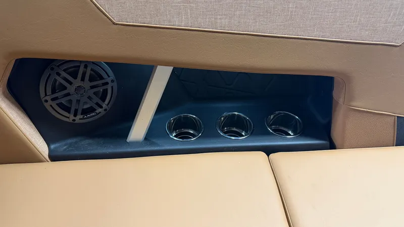 Slide: The Image of The image shows part of a boat's interior with a speaker and cup holders. - 38