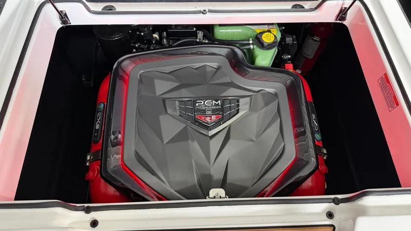 Slide: The Image of The engine compartment of a 2026 Super Air Nautique GS20 with a PCM engine, surrounded by red accents. - 20