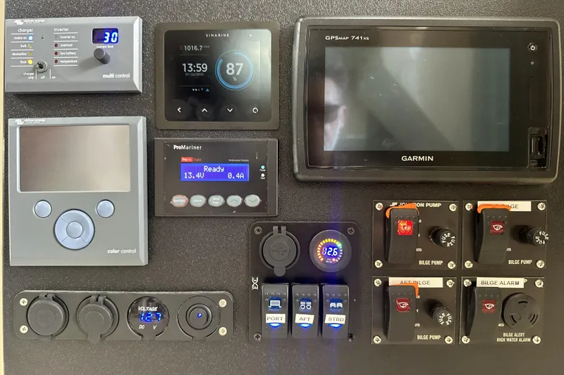 Slide: The Image of Control panel of a 1998 Mainship 40 Sedan Bridge with various electronic displays and switches. - 19