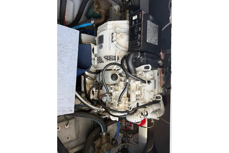 Slide: The Image of Engine compartment of 1998 Mainship 40 Sedan Bridge with visible components and wiring. - 27