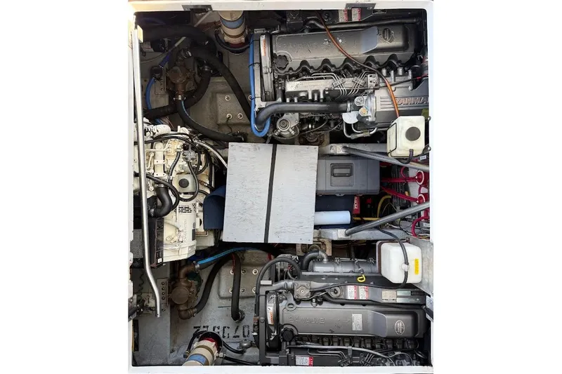 Slide: The Image of Engine compartment of a 1998 Mainship 40 Sedan Bridge boat, showcasing mechanical components. - 28