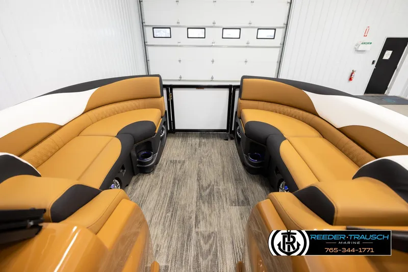 Slide: The Image of 2026 Avalon LSZ ELW boat interior with luxurious tan and black seating in a showroom. - 18
