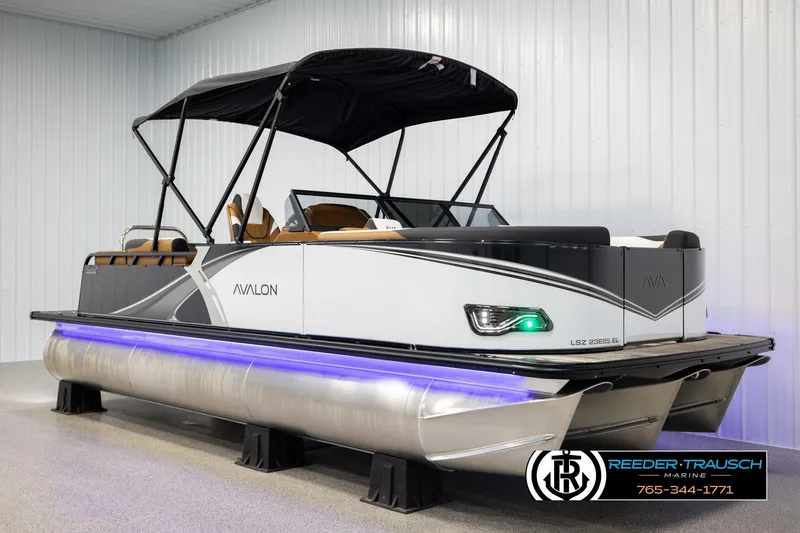 Slide: The Image of 2026 Avalon LSZ ELW pontoon boat with canopy, displayed indoors at Reeder-Trausch Marine. - 3