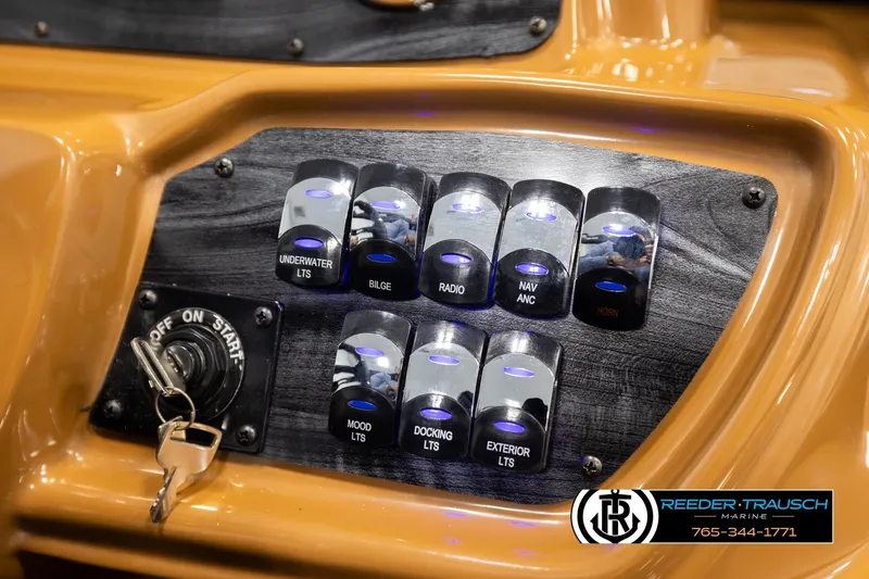 Slide: The Image of Control panel of 2026 Avalon LSZ ELW boat with labeled switches and ignition key. - 33