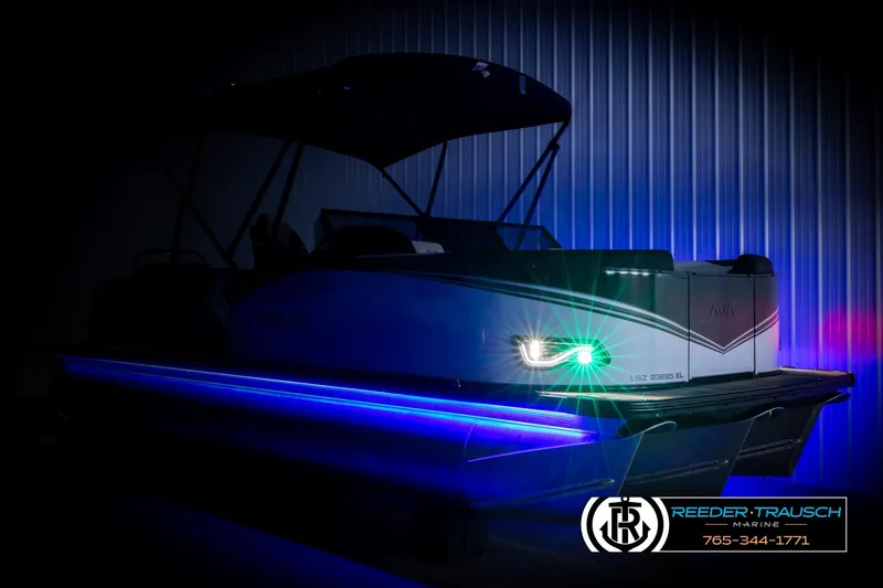 Slide: The Image of 2026 Avalon LSZ ELW pontoon boat with illuminated blue and green LED lights in a dimly lit setting. - 4