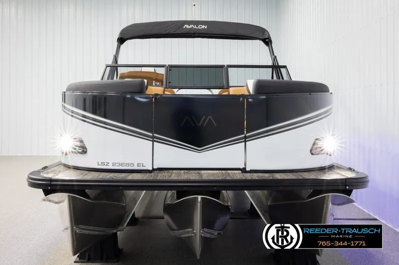 Slide: The Image of 2026 Avalon LSZ ELW pontoon boat with sleek design and illuminated headlights in showroom. - 8