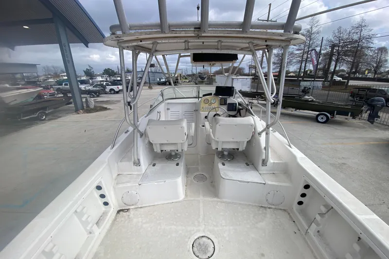 Slide: The Image of 2005 PROLINE 21 boat interior with dual seats and control panel, docked outdoors. - 10