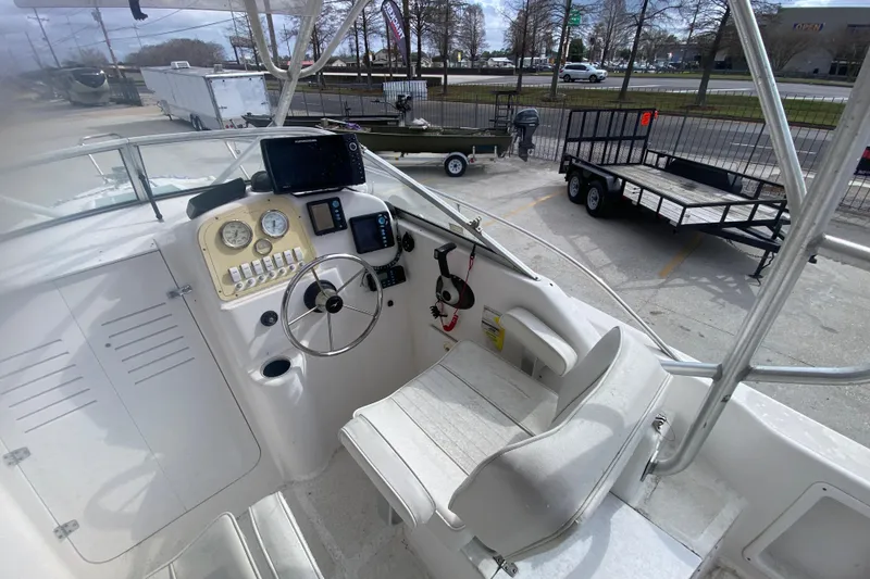 Slide: The Image of 2005 PROLINE 21 boat cockpit with steering wheel, gauges, and navigation equipment. - 11