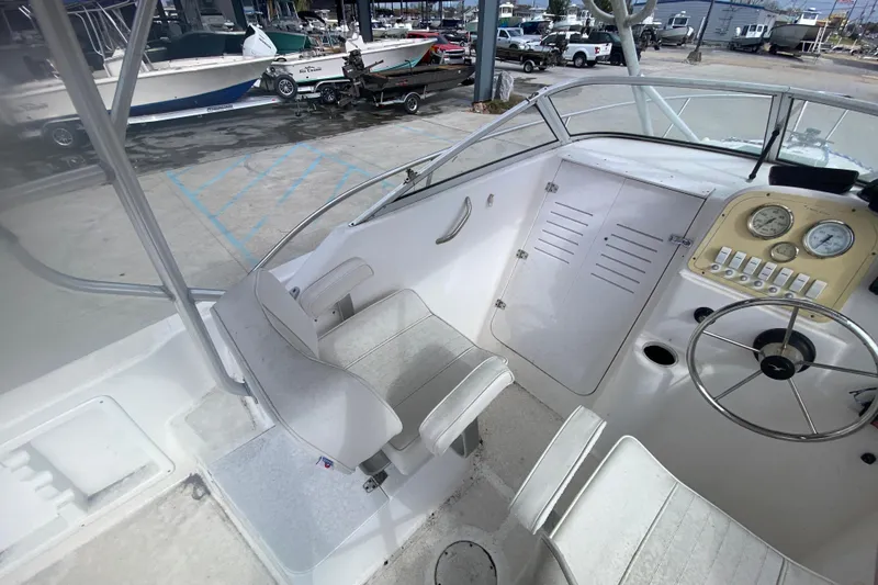 Slide: The Image of Interior of a 2005 PROLINE 21 boat, featuring steering wheel and seating. - 12
