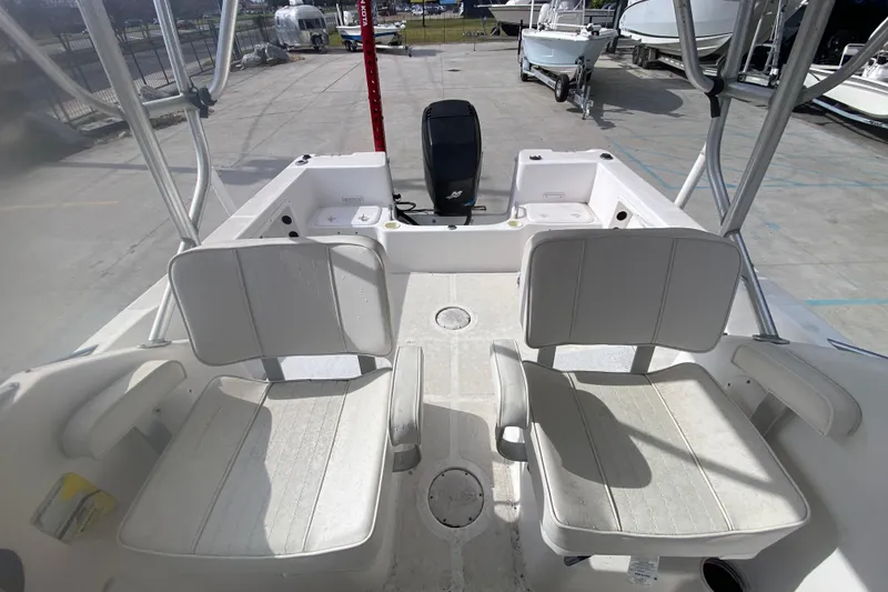 Slide: The Image of 2005 PROLINE 21 boat interior with seating and outboard motor in a marina setting. - 13