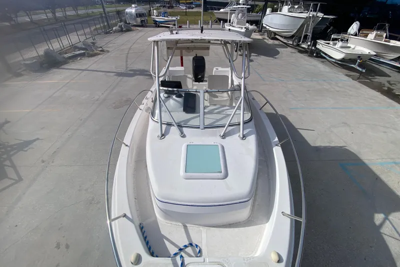 Slide: The Image of 2005 PROLINE 21 boat on concrete lot, surrounded by other boats. - 16