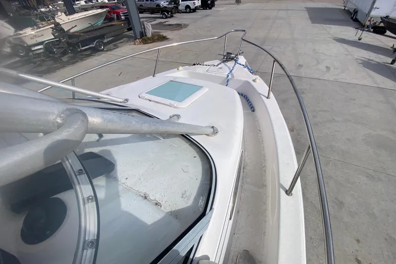 Slide: The Image of 2005 PROLINE 21 boat deck view with railing and hatch in a marina. - 18