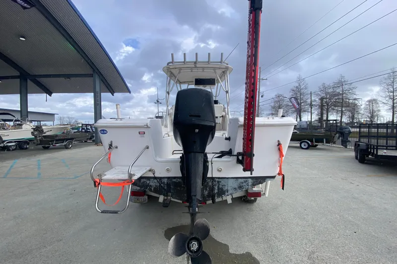 Slide: The Image of 2005 PROLINE 21 boat rear view with outboard motor in a marina setting. - 5