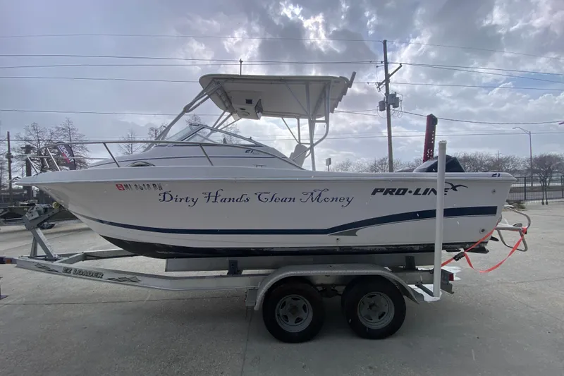 Slide: The Image of 2005 PROLINE 21 boat on trailer, labeled "Dirty Hands Clean Money," under cloudy sky. - 7