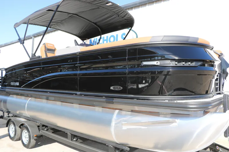 Slide: The Image of 2026 Sylvan L3 DLZ Bar Tri-Toon boat with sleek black design on trailer. - 11