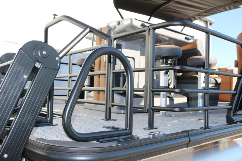 Slide: The Image of 2026 Sylvan L3 DLZ Bar Tri-Toon boat interior with seating and railings. - 12