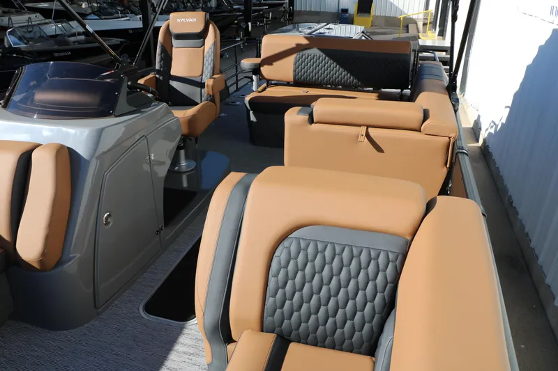 Slide: The Image of 2026 Sylvan L3 DLZ Bar Tri-Toon interior with luxurious tan and gray seating. - 18