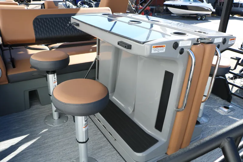 Slide: The Image of 2026 Sylvan L3 DLZ Bar Tri-Toon interior with bar stools and seating area. - 23