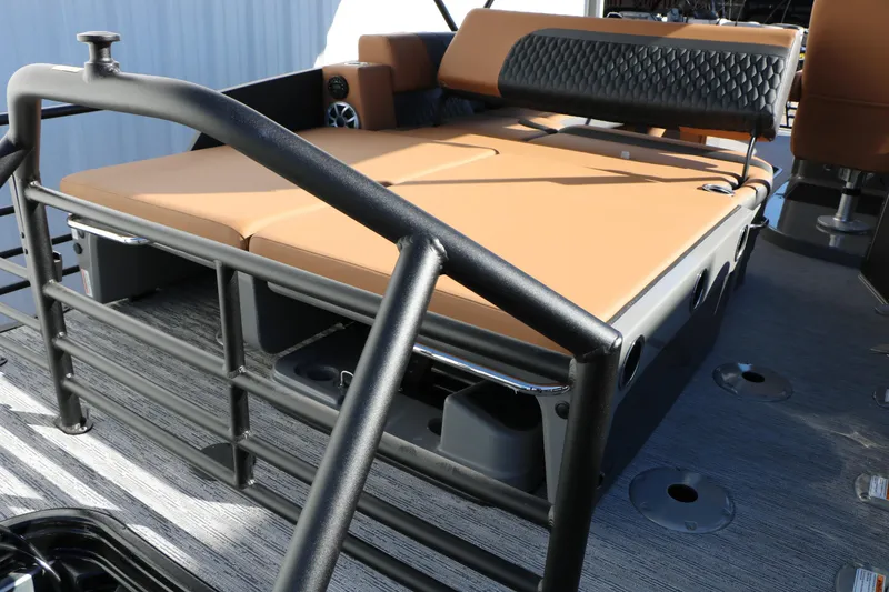 Slide: The Image of 2026 Sylvan L3 DLZ Bar Tri-Toon boat interior with tan seating and black railing. - 26