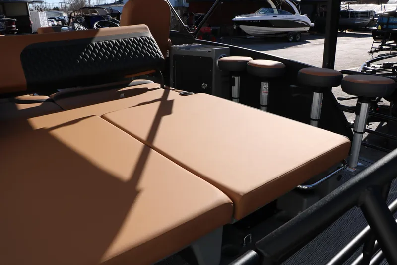 Slide: The Image of 2026 Sylvan L3 DLZ Bar Tri-Toon with tan seating and bar stools. - 28