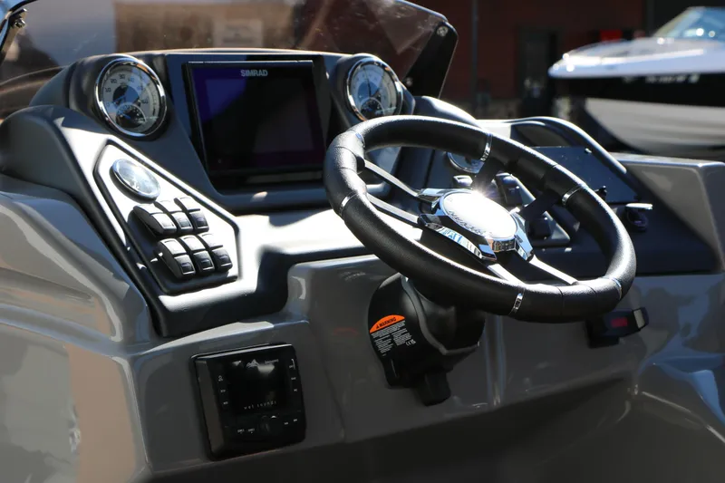 Slide: The Image of Steering console of 2026 Sylvan L3 DLZ Bar Tri-Toon boat with modern controls. - 33