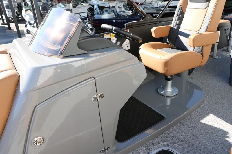 Slide: The Image of 2026 Sylvan L3 DLZ Bar Tri-Toon boat interior with tan seating and helm. - 35