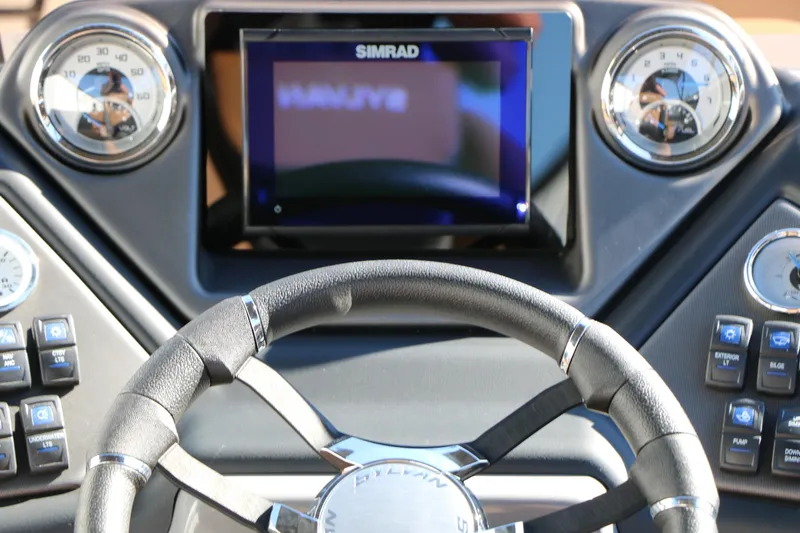 Slide: The Image of Dashboard of 2026 Sylvan L3 DLZ Bar Tri-Toon with steering wheel and controls. - 38