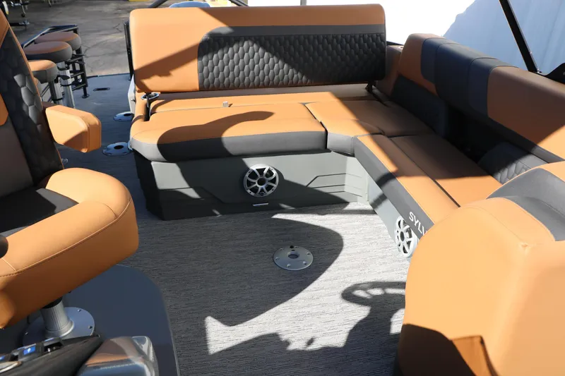 Slide: The Image of Luxurious seating on 2026 Sylvan L3 DLZ Bar Tri-Toon boat, featuring tan and black upholstery. - 40