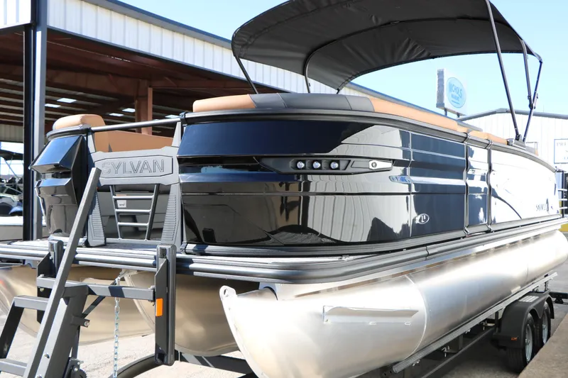 Slide: The Image of 2026 Sylvan L3 DLZ Bar Tri-Toon pontoon boat with sleek black design. - 7