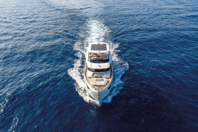 Slide: The Image of Aerial view of 2027 Absolute Navetta 66 yacht cruising on open sea. - 4