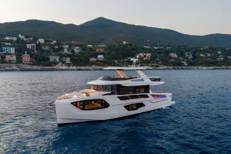 Slide: The Image of Luxurious 2027 Absolute Navetta 66 yacht cruising near scenic coastal landscape. - 15