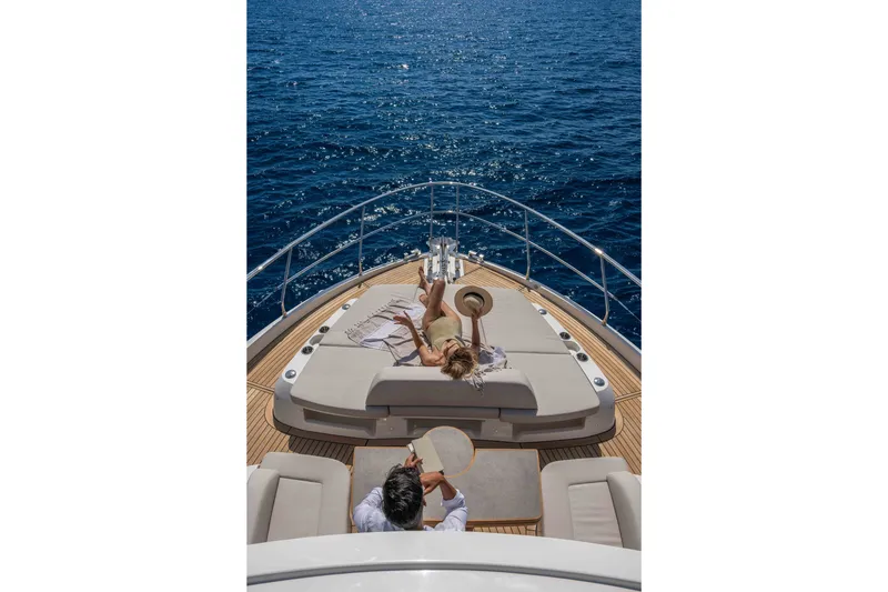 Slide: The Image of Couple relaxing on the deck of a 2027 Absolute Navetta 66 yacht, enjoying the ocean view. - 30