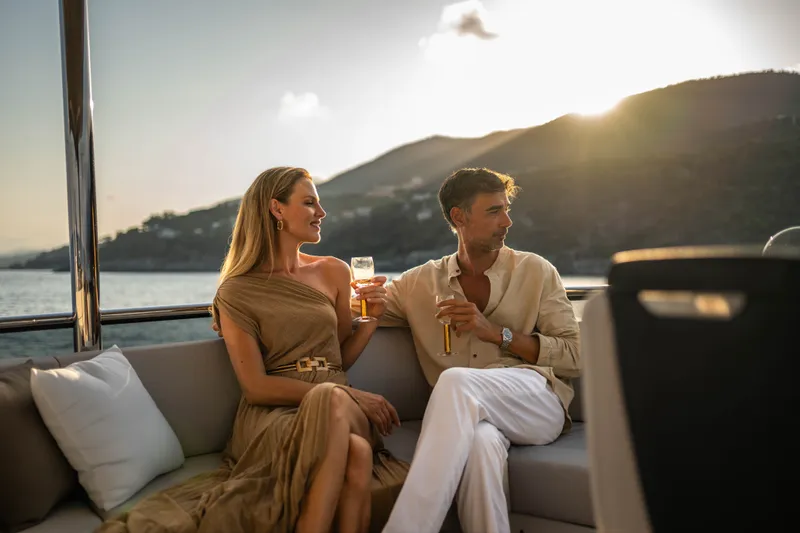 Slide: The Image of Couple enjoying sunset on Absolute Navetta 66 yacht, 2027 model, with scenic ocean view. - 35