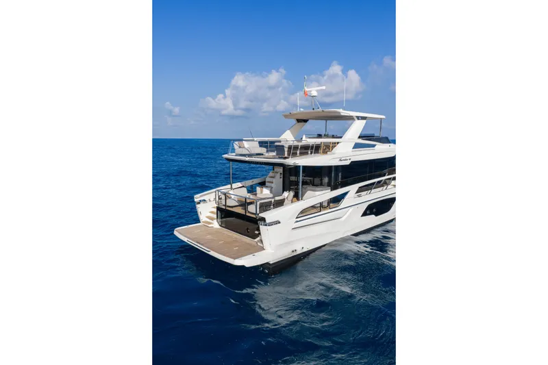 Slide: The Image of Luxury yacht Absolute Navetta 66, 2027 model, cruising on open sea under clear blue sky. - 13