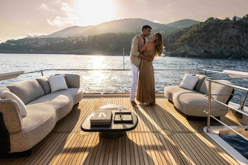 Slide: The Image of Couple enjoying sunset on Absolute Navetta 66 yacht, 2027 model, with scenic ocean backdrop. - 39