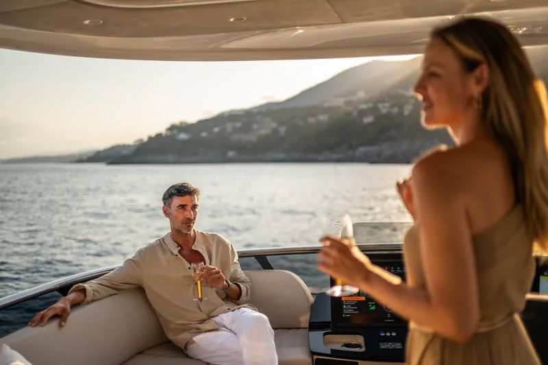 Slide: The Image of Couple enjoying drinks on Absolute Navetta 66 yacht, 2027 model, with scenic ocean view. - 34
