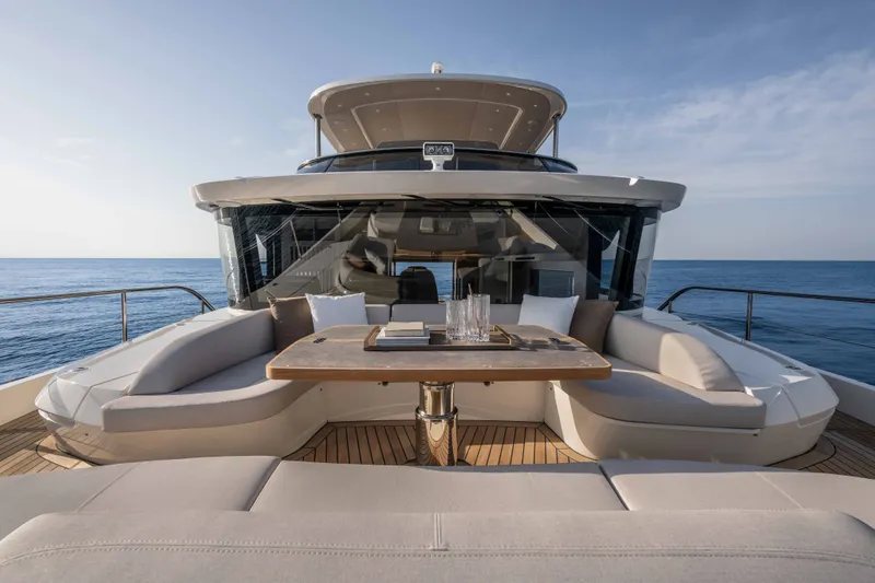 Slide: The Image of Luxurious 2027 Absolute Navetta 66 yacht with elegant outdoor seating and ocean view. - 26